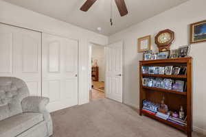 Sitting room with carpet flooring and ceiling fan