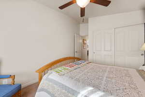 Bedroom featuring carpet flooring, a closet, and a ceiling fan