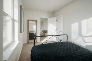Carpeted bedroom featuring baseboards