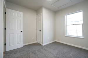 Unfurnished room featuring baseboards and carpet
