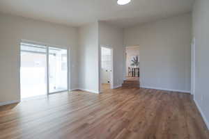 Empty room with light wood-style flooring and baseboards
