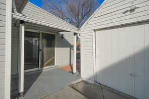 View of exterior entry featuring a patio