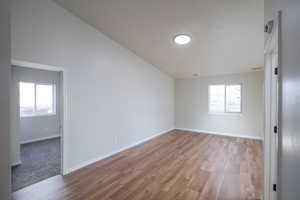Spare room featuring light wood-style flooring and healthy amount of natural light