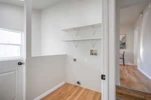 Washroom featuring light wood-style floors, washer hookup, and electric dryer hookup