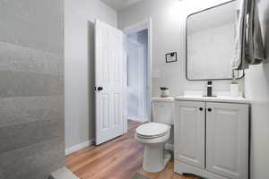 Half bath featuring vanity and light wood-type flooring