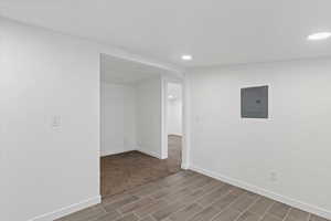 Empty room with electric panel and recessed lighting
