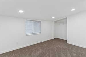 Unfurnished bedroom featuring carpet, recessed lighting, and a closet