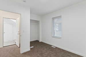 Unfurnished bedroom featuring carpet floors and a closet