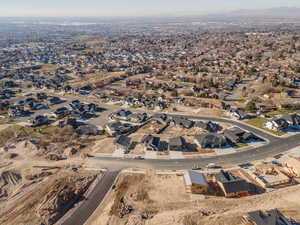 Aerial overview of property's location featuring nearby suburban area and mountains
