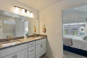 Full bath with double vanity, plenty of natural light, ensuite bathroom, and recessed lighting
