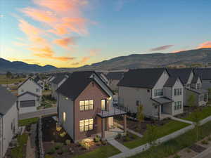 View of front facade featuring a residential view, a mountain view, brick siding, and a porch