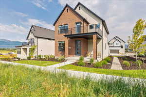 Modern home featuring brick siding and driveway