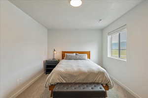 Carpeted bedroom featuring baseboards