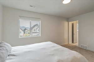 Carpeted bedroom featuring baseboards