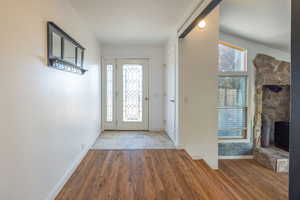 Entryway with wood finished floors and healthy amount of natural light