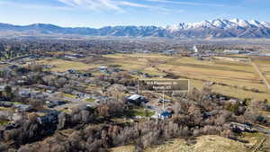Aerial view of property's location featuring a mountainous background