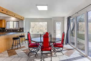 Dining area with light tile patterned flooring