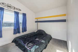 Upstairs Carpeted bedroom featuring vaulted ceiling