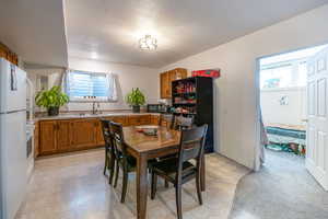 Dining space with light flooring and a textured ceiling