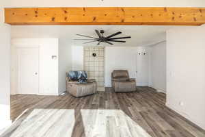 Living area featuring wood finished floors and ceiling fan