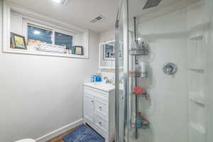 3/4 bathroom with vanity and a stall shower