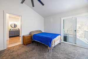 Main floor ensuite Bedroom with lofted ceiling, carpet, a ceiling fan, access to outside, and ensuite bathroom and private deck,