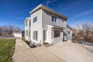View of side of home with a patio area and a garage