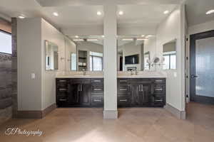 Bathroom featuring two vanities, recessed lighting, and a walk in shower