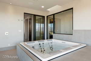 Bathroom with a whirlpool tub and recessed lighting