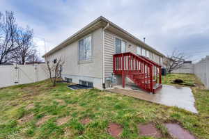 Rear view of house featuring a gate and a fenced backyard