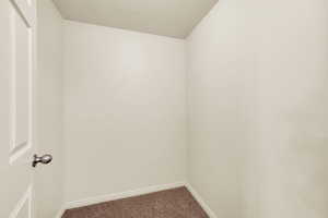 Spare room with carpet flooring and a textured ceiling