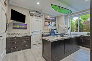 Office space with crown molding, recessed lighting, and light wood-style floors