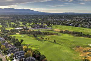 Aerial view of residential area with a golf club and a mountain backdrop