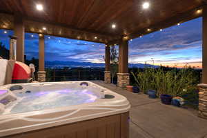 View of patio / terrace featuring a mountain view and a hot tub