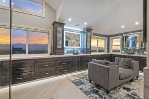 Full bathroom with vanity, vaulted ceiling, recessed lighting, light wood-style floors, and tasteful backsplash