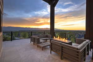 Balcony with an outdoor living space with a fire pit and a mountain view