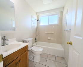 Full bathroom featuring vanity, washtub / shower combination, and light tile patterned floors