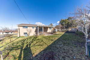 Back of property featuring brick siding and a patio area