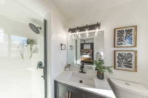 Ensuite bathroom featuring vanity and a stall shower