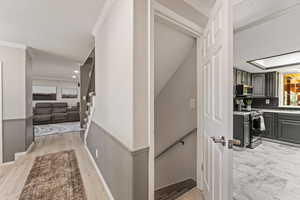 Stairway featuring crown molding