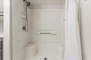 Full bath featuring a shower with shower curtain