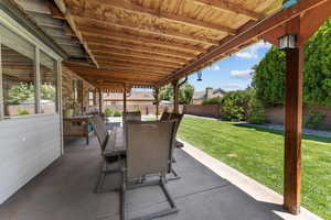 Fenced backyard with a patio area and outdoor dining area