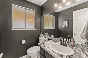 Half bathroom featuring toilet and vanity