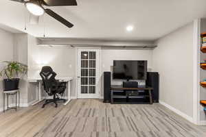 Office space with light wood-style flooring, a ceiling fan, and recessed lighting