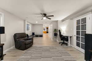 Home office with a ceiling fan, light wood-style floors, and recessed lighting