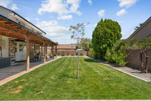 Fenced backyard featuring a patio
