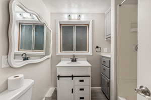 Bathroom featuring vanity and a shower