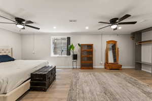 Bedroom featuring ceiling fan, recessed lighting, light wood finished floors, and ornamental molding