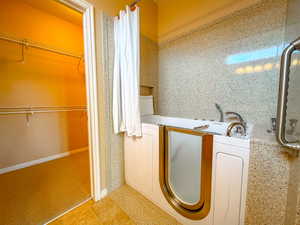primary bathroom with walk in tub