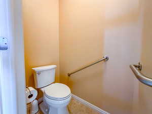 primary bathroom water closet with grab bars